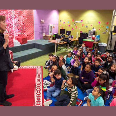 "How many of you have seen a giraffe?" queries Debra Young Hatch as she prepares to read to kids at Hicks Elementary.